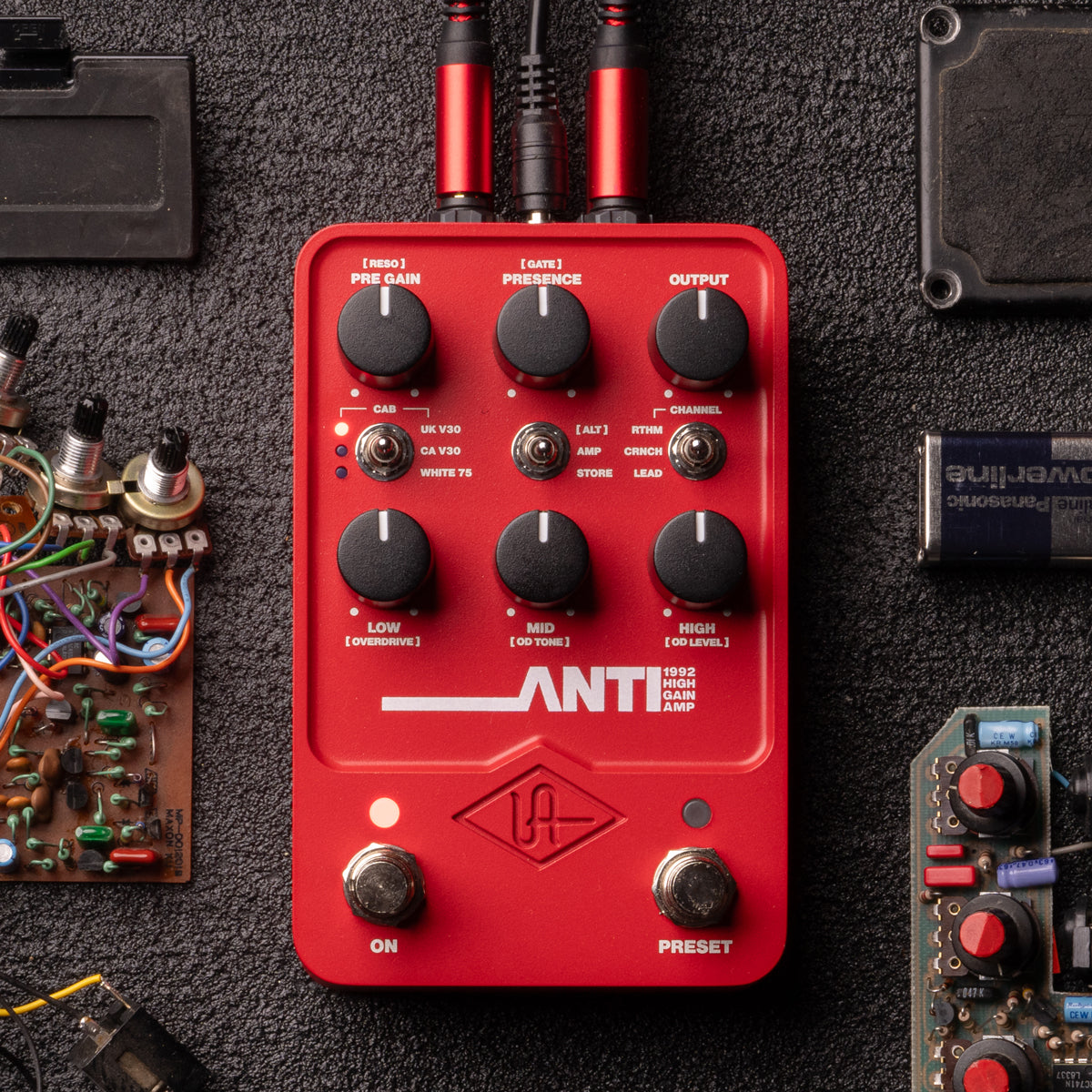Universal Audio UAFX ANTI 1992 High Gain Amp effect pedal surrounded by components