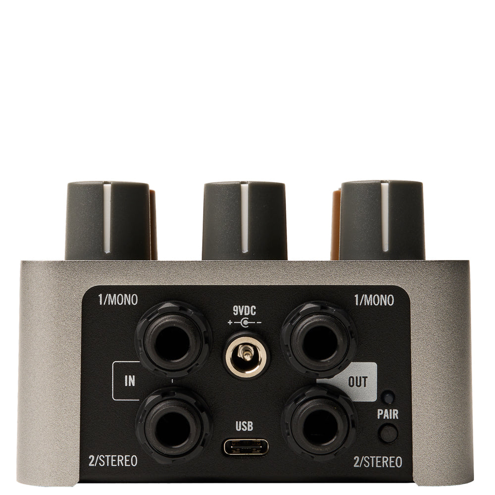 input and output channels from a Universal Audio UAFX OX Stomp Dynamic Speaker Emulator Pedal in grey metal with black and brown knobs