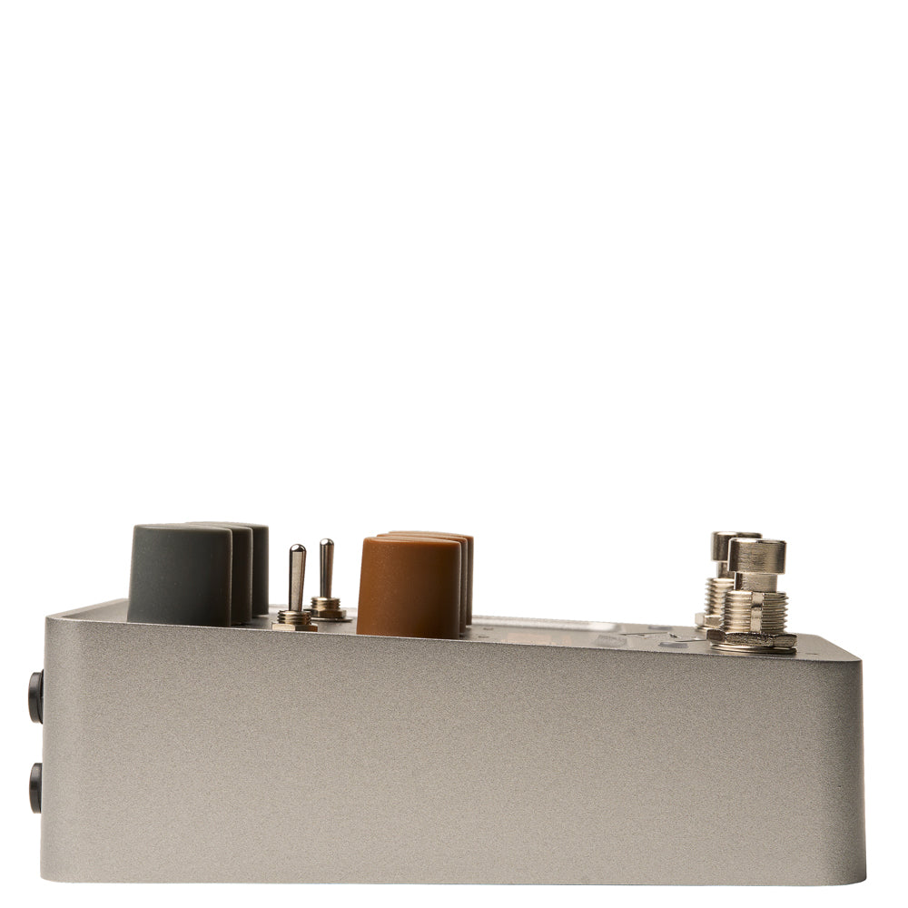 side view of a Universal Audio UAFX OX Stomp Dynamic Speaker Emulator Pedal in grey metal with black and brown knobs