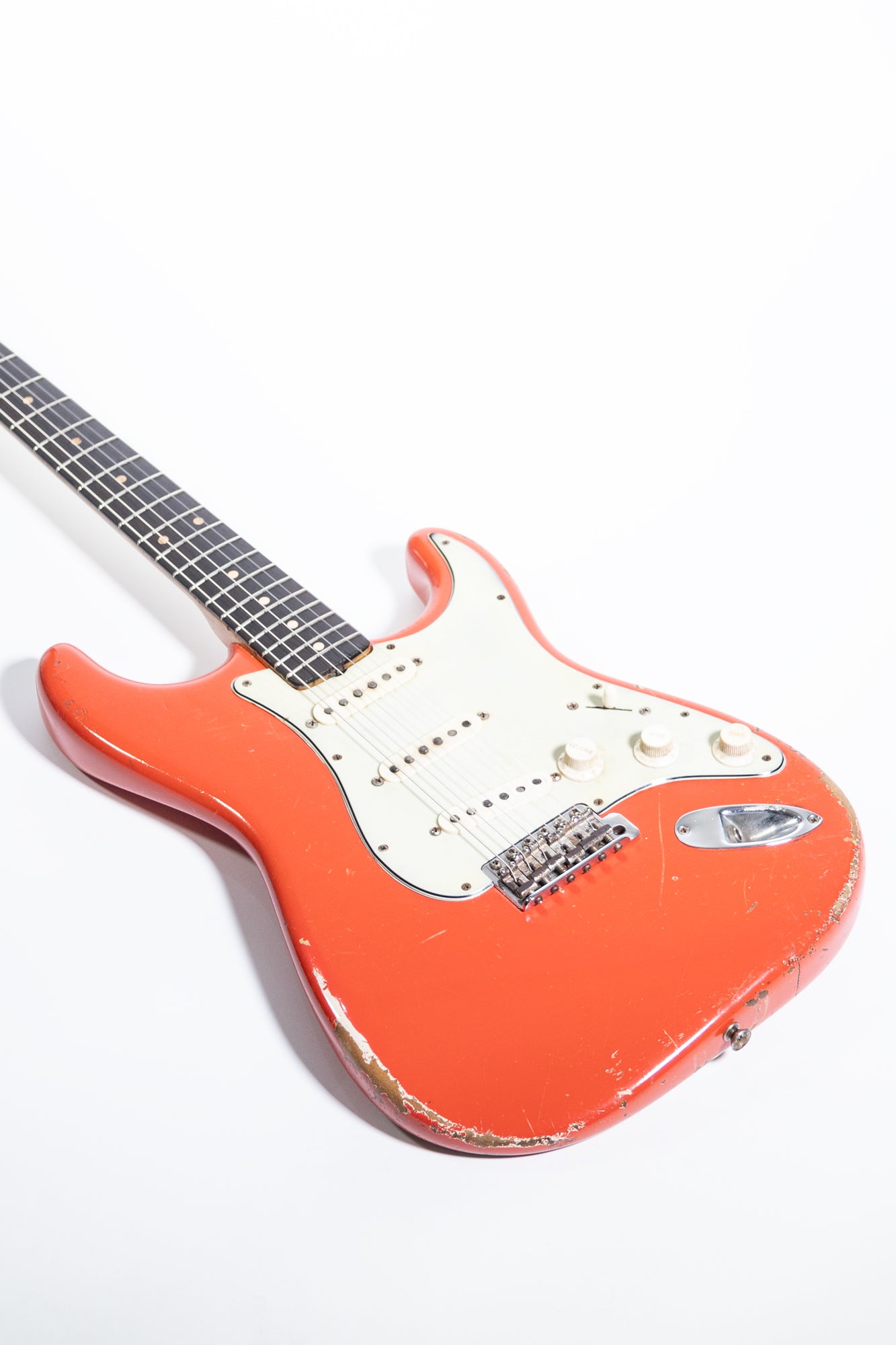 side profile of the body front of a 1963 Fender Stratocaster finished in Fiesta Red