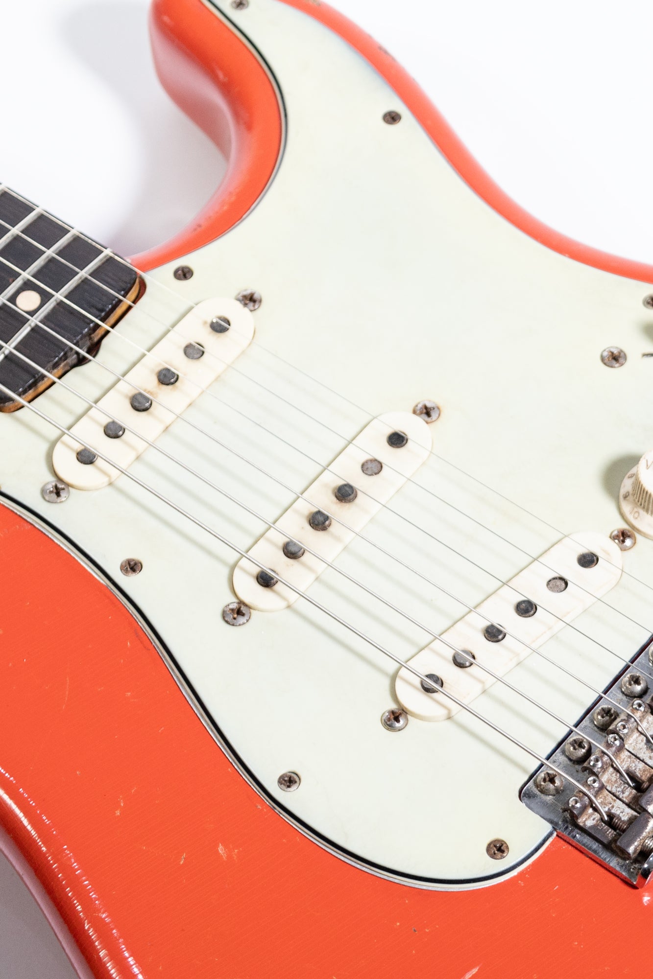 close up of a 1963 Fender Stratocaster's single coil pickups and pick guard