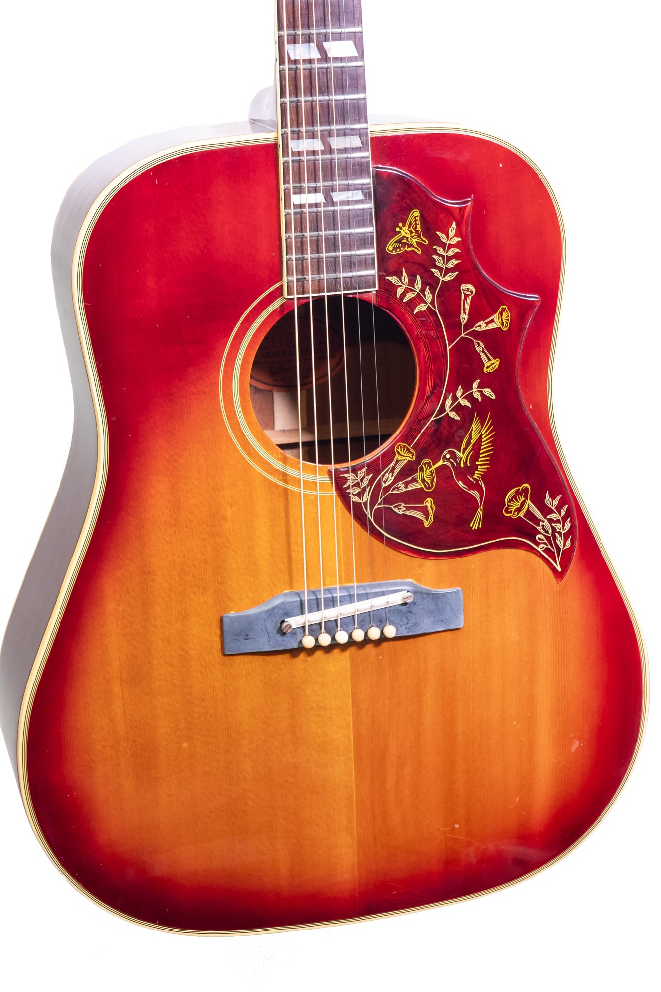 closeup of a Original vintage 1963 Gibson Hummingbird Acoustic Guitar in 'cherry burst'