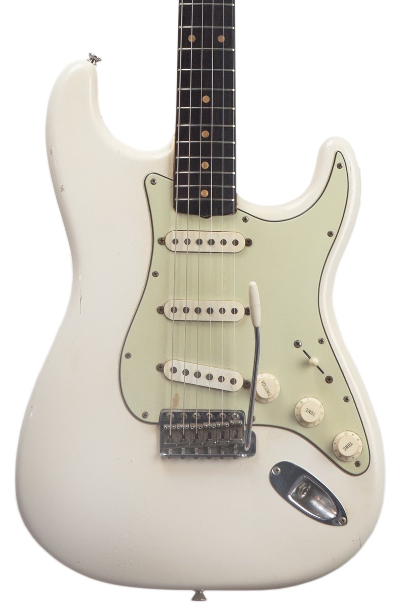 front of a original vintage 1963 Fender Stratocaster - Olympic White electric guitar