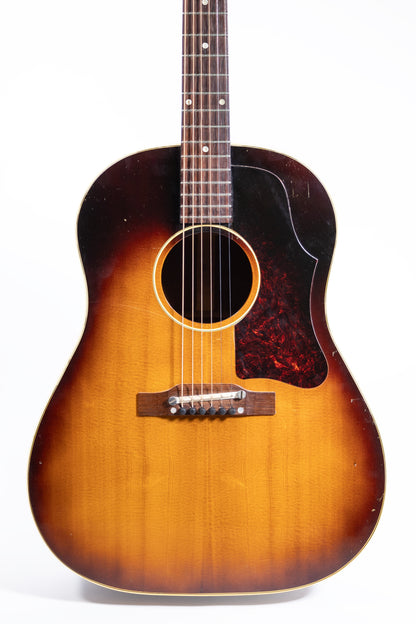 front of a vintage 1957 Gibson J-45 ADJ acoustic guitar