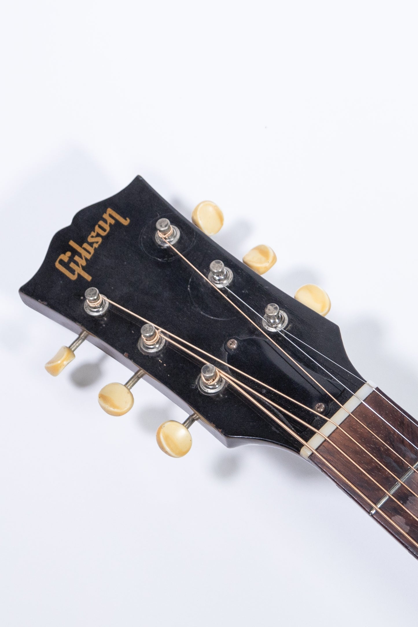 headstock of a vintage 1957 Gibson J-45 ADJ acoustic guitar